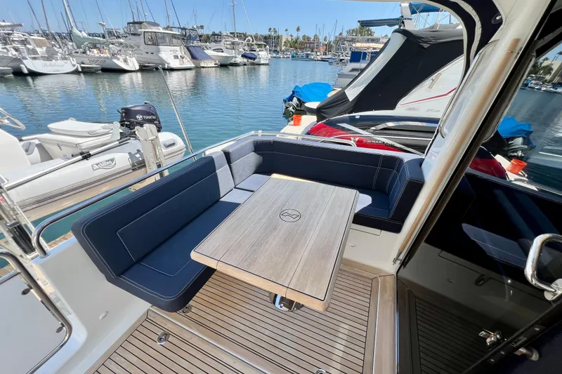 Slide: The Image of Luxurious 2018 Nimbus 365 Coupe yacht interior with elegant seating and table in marina. - 42
