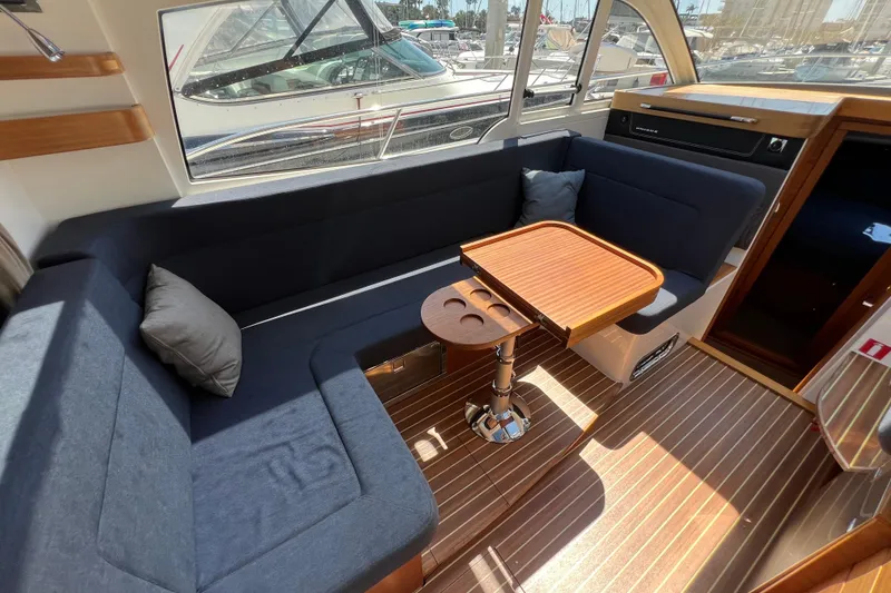 Slide: The Image of Interior of 2018 Nimbus 365 Coupe with cozy seating and wooden table. - 77