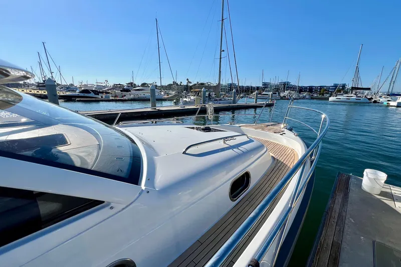 Slide: The Image of 2018 Nimbus 365 Coupe yacht docked at a marina with clear blue skies. - 8