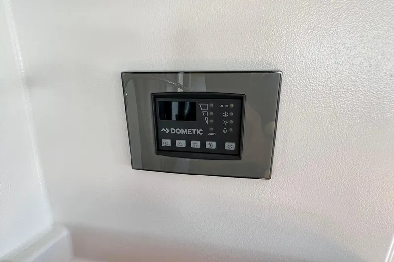 Slide: The Image of Dometic control panel on 2018 Nimbus 365 Coupe boat interior wall. - 125
