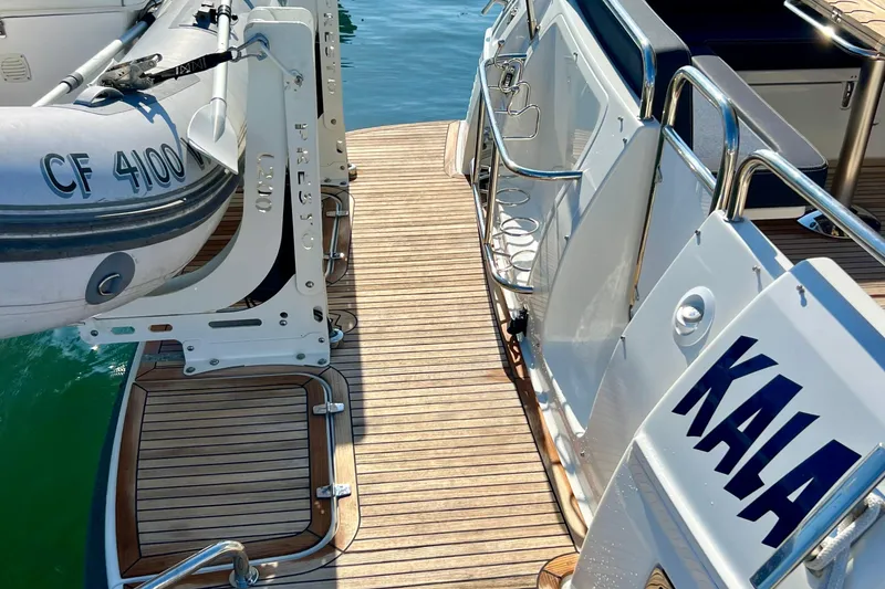 Slide: The Image of 2018 Nimbus 365 Coupe yacht with wooden deck and attached inflatable boat. - 14