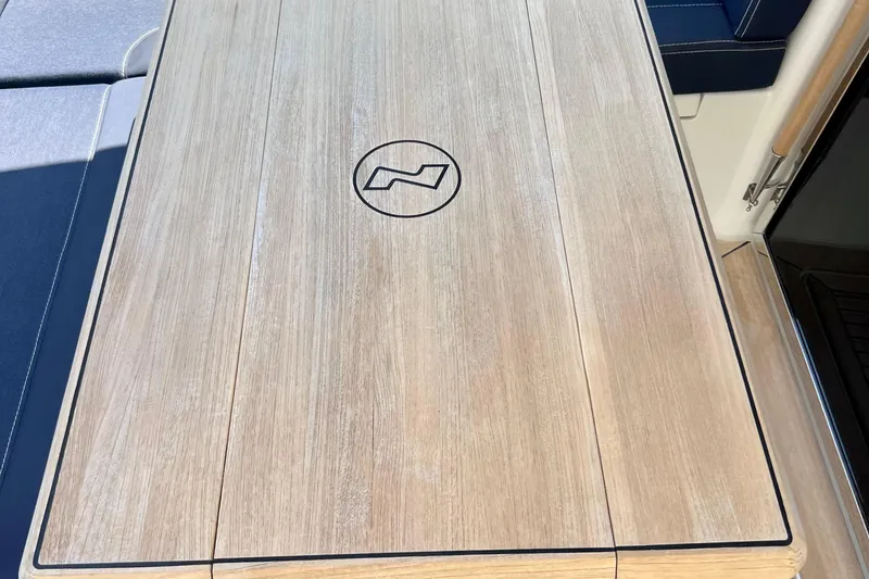 Slide: The Image of Wooden table on 2018 Nimbus 365 Coupe boat with logo engraving. - 47