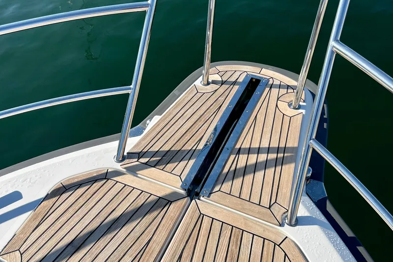 Slide: The Image of Bow deck of 2018 Nimbus 365 Coupe with teak flooring and stainless steel railings. - 24