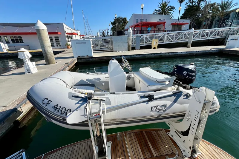 Slide: The Image of Inflatable boat with Tohatsu motor docked at marina, near Nimbus 365 Coupe, 2018 model. - 38