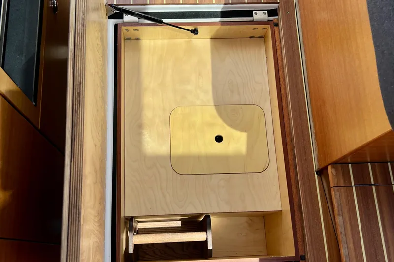 Slide: The Image of Wooden storage compartment in 2018 Nimbus 365 Coupe boat interior. - 117