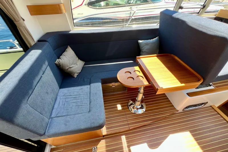 Slide: The Image of Interior of 2018 Nimbus 365 Coupe with blue seating and wooden table. - 76