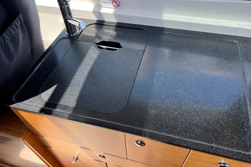 Slide: The Image of Modern kitchen sink in 2018 Nimbus 365 Coupe boat, featuring sleek black countertop. - 107