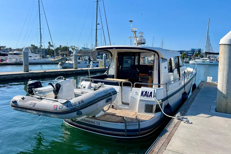 Slide: The Image of 2018 Nimbus 365 Coupe docked with inflatable boat, marina background. - 16