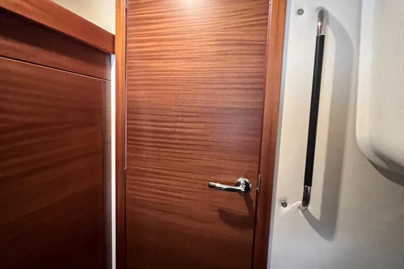 Slide: The Image of Wooden interior door with chrome handle in 2018 Nimbus 365 Coupe boat. - 153