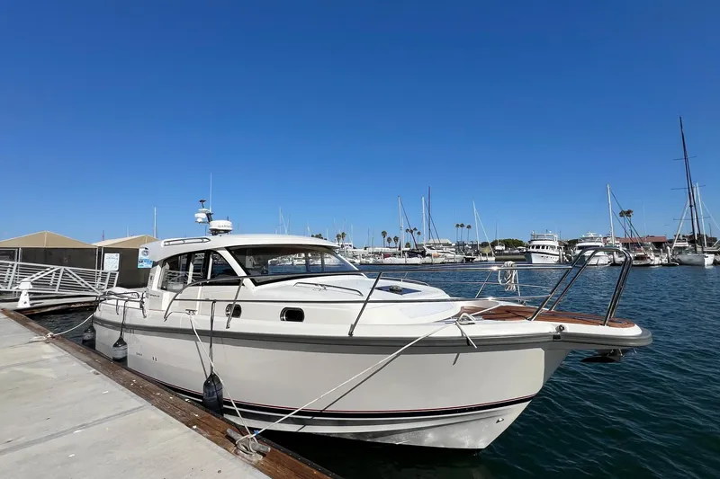 Slide: The Image of 2018 Nimbus 365 Coupe docked at a marina under clear blue skies. - 6
