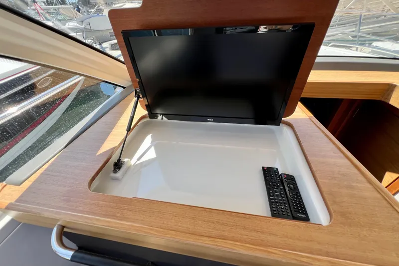 Slide: The Image of Built-in TV and remote controls on 2018 Nimbus 365 Coupe yacht interior. - 87