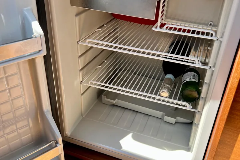 Slide: The Image of Open fridge in 2018 Nimbus 365 Coupe with bottles on shelves. - 110