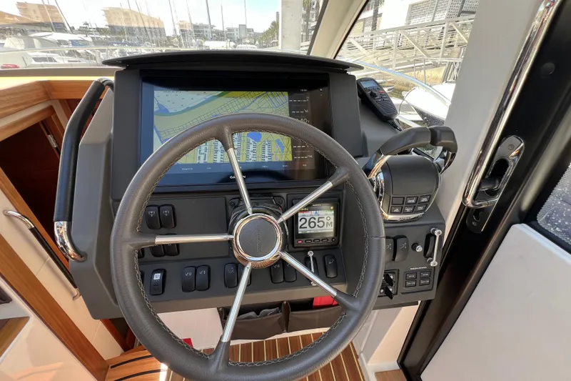 Slide: The Image of Steering wheel and dashboard of 2018 Nimbus 365 Coupe with navigation display. - 94