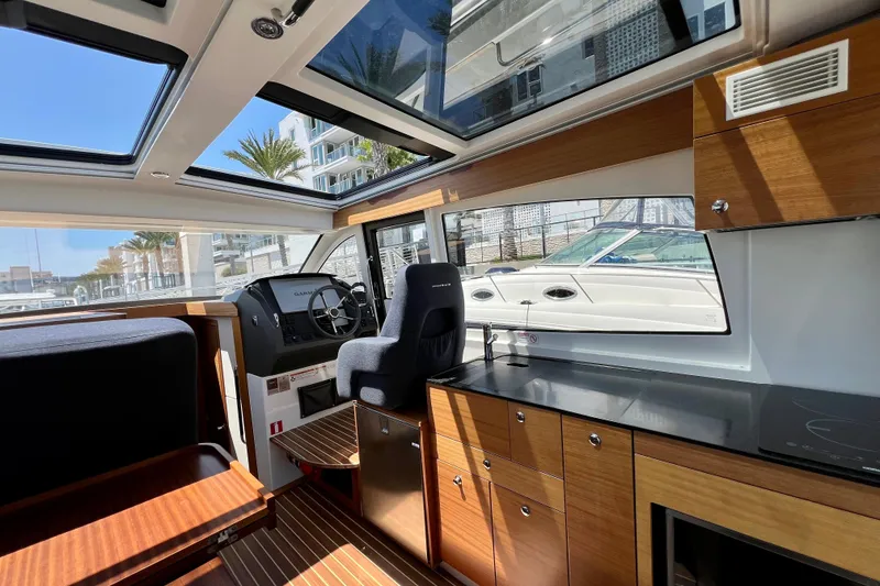 Slide: The Image of Interior of 2018 Nimbus 365 Coupe boat with modern helm and kitchen area. - 89