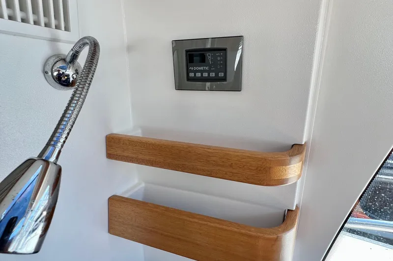 Slide: The Image of Interior of 2018 Nimbus 365 Coupe with control panel and wooden shelves. - 124