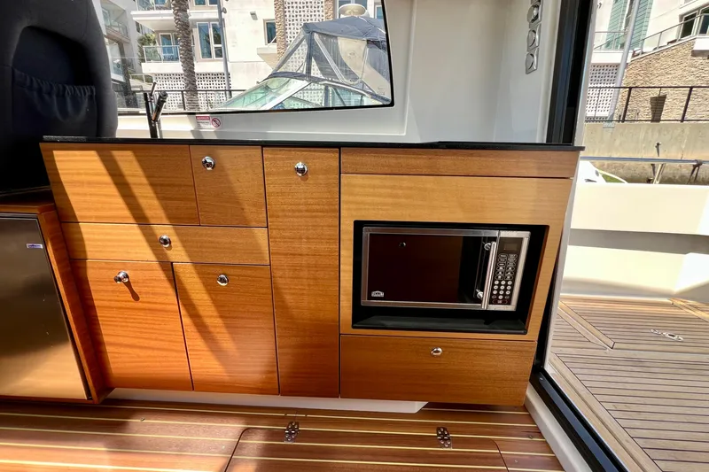Slide: The Image of Wooden interior of 2018 Nimbus 365 Coupe with microwave and cabinets. - 111