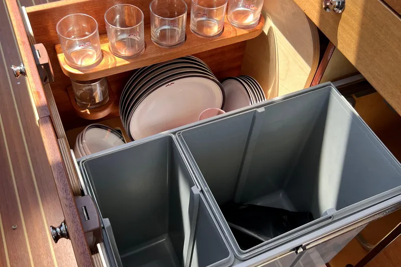 Slide: The Image of Kitchen storage in 2018 Nimbus 365 Coupe with glasses, plates, and bins. - 116