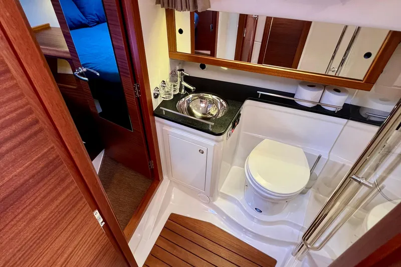 Slide: The Image of Luxurious bathroom in 2018 Nimbus 365 Coupe yacht with modern fixtures and wooden accents. - 142