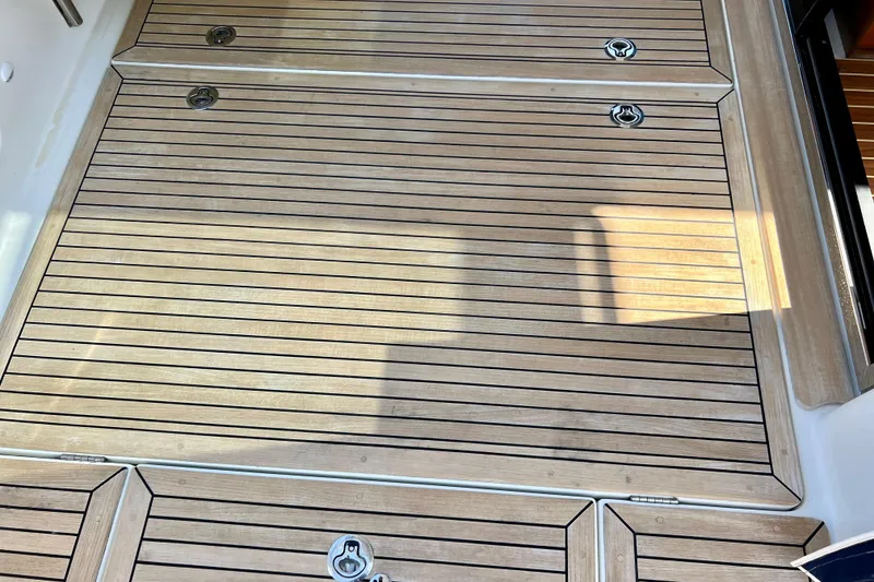 Slide: The Image of Teak deck of 2018 Nimbus 365 Coupe, featuring sleek, polished wood finish. - 52