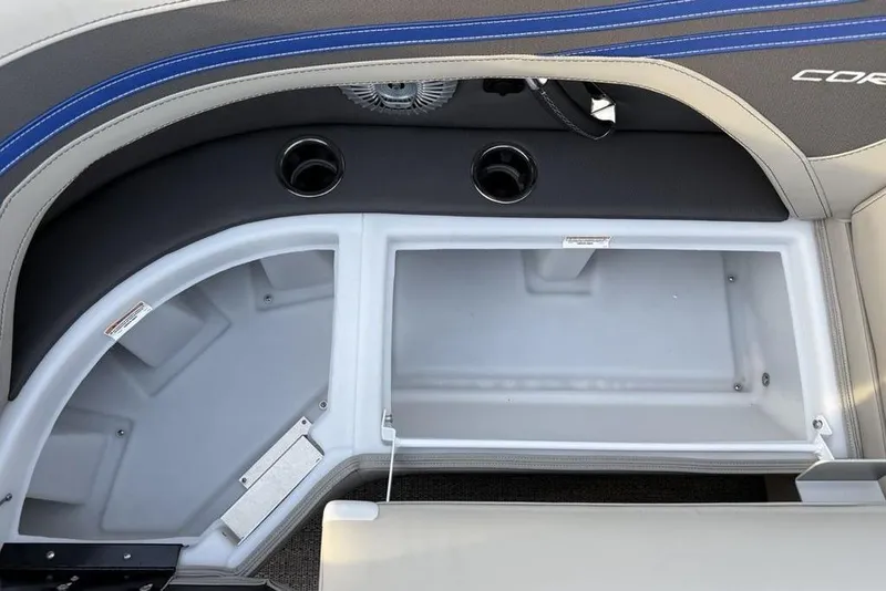 Slide: The Image of 2025 Barletta 23UC boat storage compartment with cup holders and sleek design. - 11