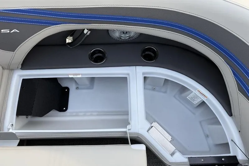 Slide: The Image of Storage compartment in 2025 Barletta 23UC boat with cup holders and blue accents. - 12