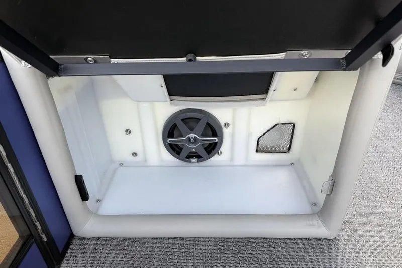 Slide: The Image of Storage compartment with speaker in 2025 Barletta 23UC boat, featuring sleek interior design. - 13
