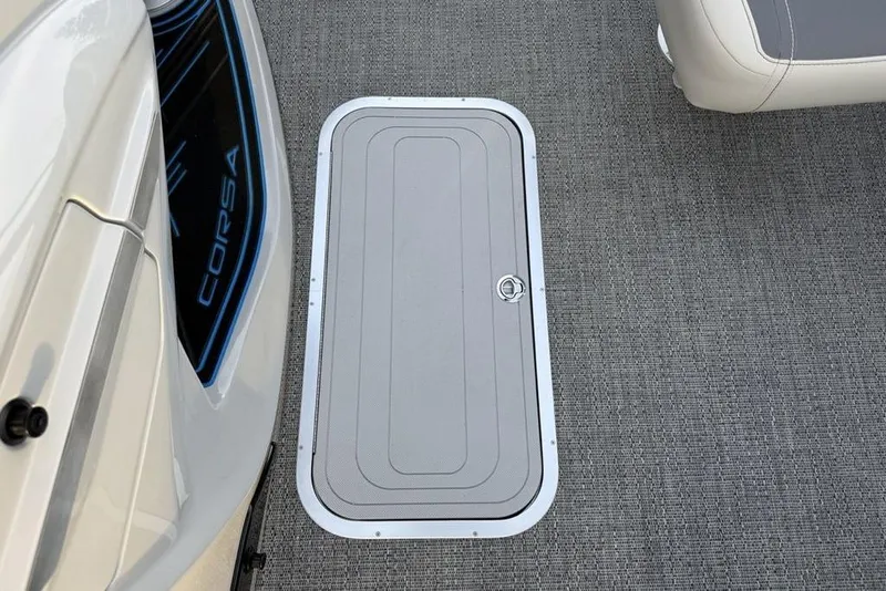 Slide: The Image of 2025 Barletta 23UC boat floor with storage hatch and Corsa branding. - 14