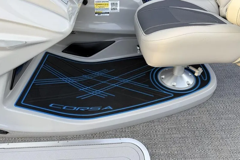 Slide: The Image of Captain's seat area of 2025 Barletta 23UC boat with Corsa branding. - 18