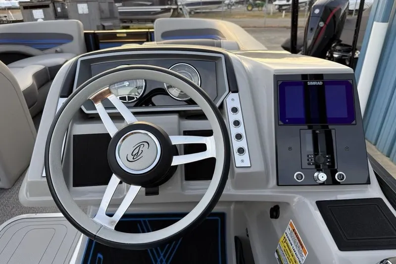 Slide: The Image of 2025 Barletta 23UC boat dashboard with steering wheel and Simrad display. - 21