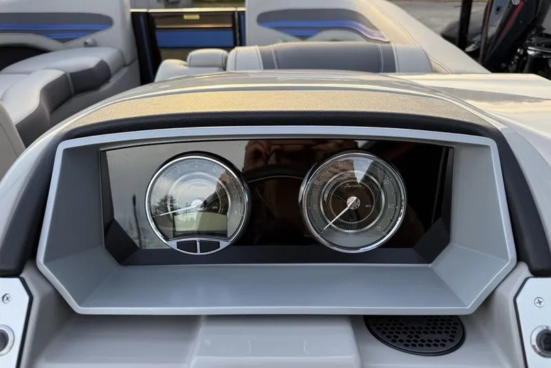 Slide: The Image of Dashboard of 2025 Barletta 23UC boat with modern gauges and seating in background. - 22