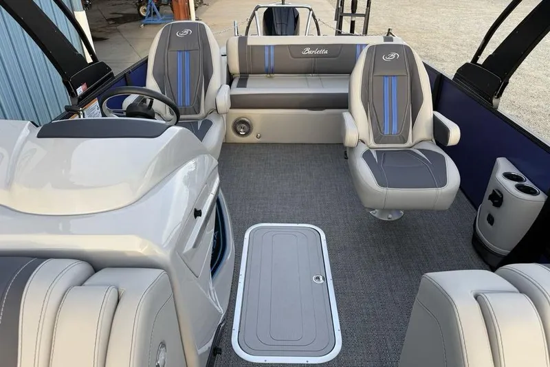 Slide: The Image of 2025 Barletta 23UC boat interior with modern seating and steering console. - 23