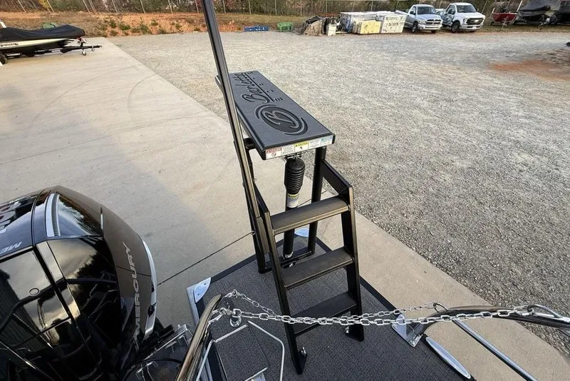 Slide: The Image of 2025 Barletta 23UC boat with ladder and Mercury engine in a parking area. - 31