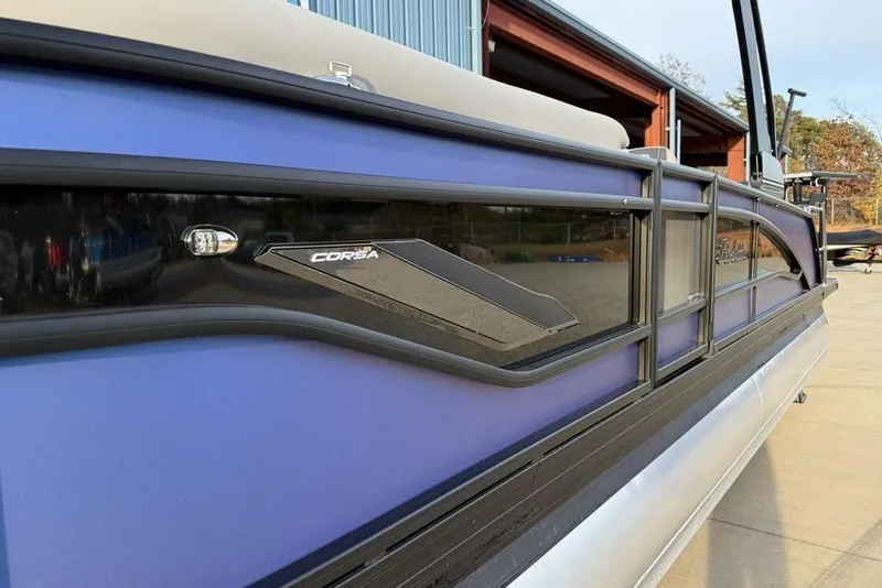 Slide: The Image of 2025 Barletta 23UC pontoon boat with sleek blue exterior and Corsa branding. - 6