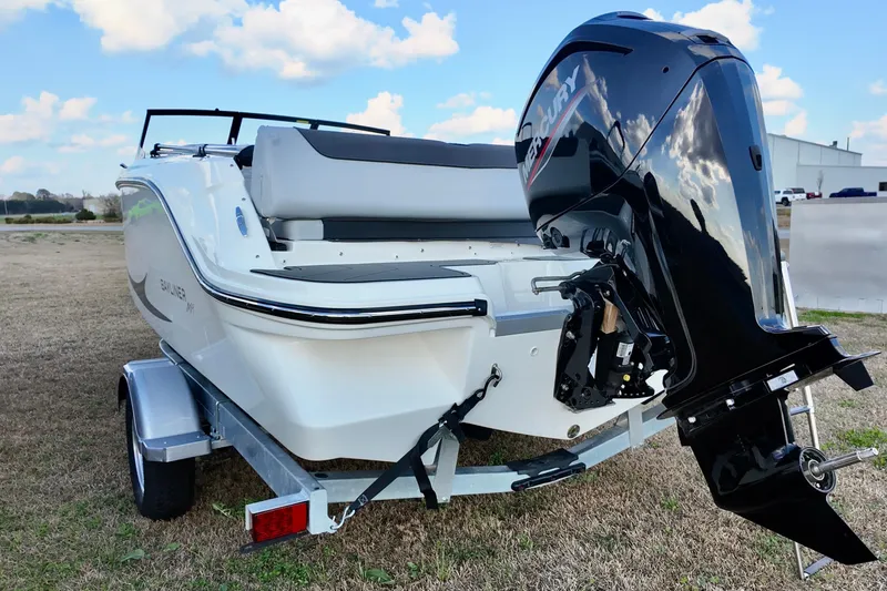 Slide: The Image of 2026 Bayliner Element M19 boat with Mercury outboard motor on trailer. - 11