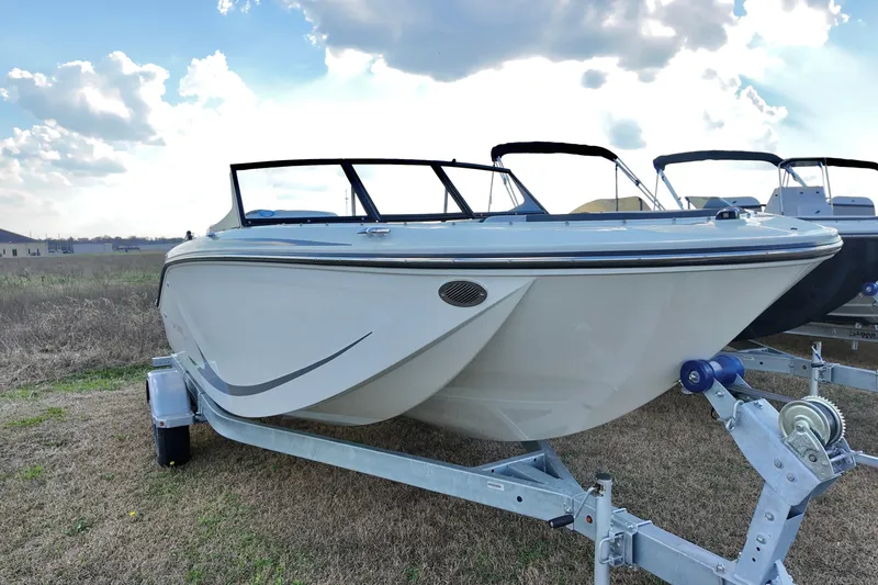 Slide: The Image of 2026 Bayliner Element M19 boat on trailer under cloudy sky. - 13