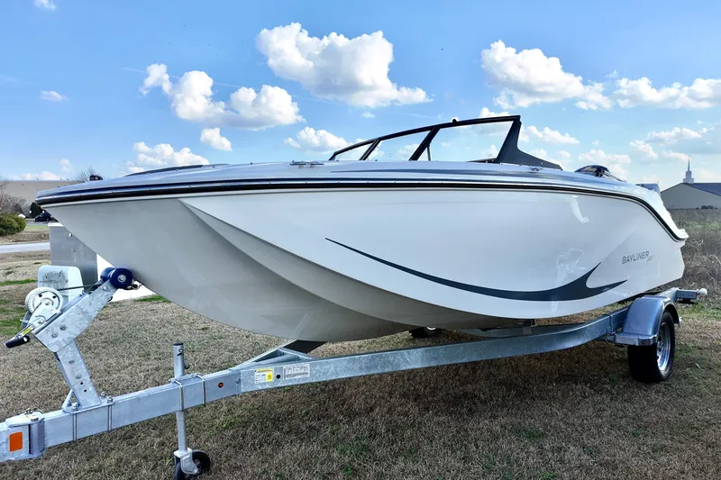 The Image of 2026 Bayliner Element M19 boat on trailer under a blue sky. - 2