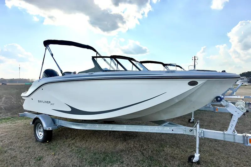 Slide: The Image of 2026 Bayliner Element M19 boat on trailer under blue sky. - 3