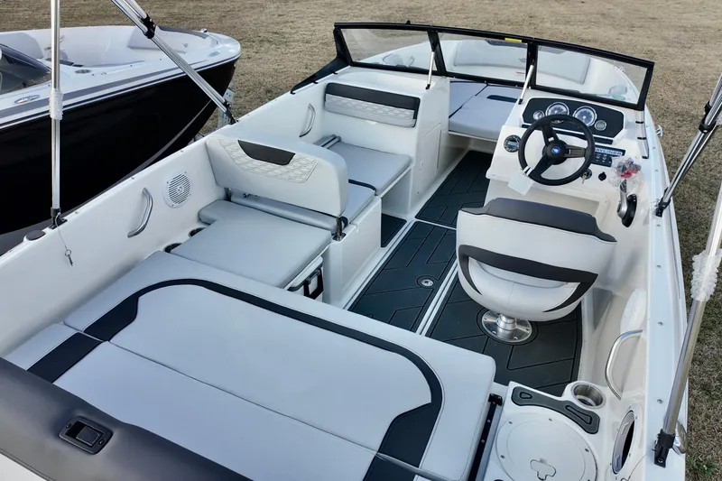 Slide: The Image of 2026 Bayliner Element M19 boat interior with modern seating and steering console. - 5