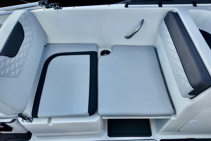 Slide: The Image of 2026 Bayliner Element M19 boat interior seating with modern design and cup holder. - 7