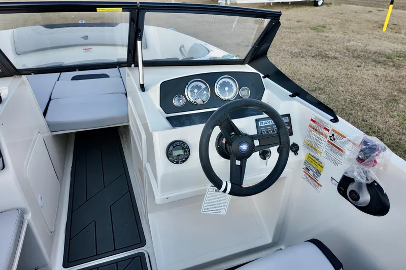 Slide: The Image of 2026 Bayliner Element M19 boat interior with steering wheel and dashboard controls. - 9
