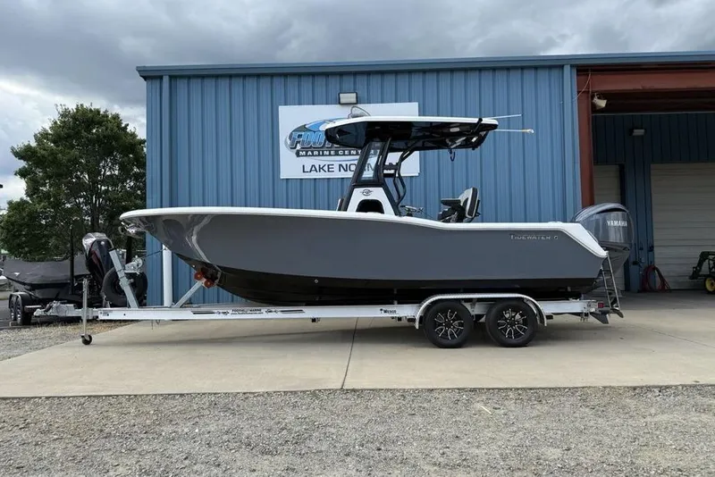 The Image of 2026 Tidewater 232 CC Adventure boat on trailer at marine center. - 1