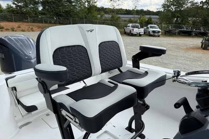 Slide: The Image of 2026 Tidewater 232 CC Adventure boat seats with armrests, parked outdoors. - 10