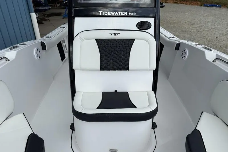 Slide: The Image of 2026 Tidewater 232 CC Adventure boat interior with white and black seating. - 11