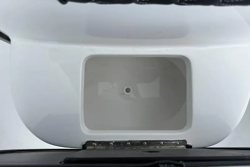 Slide: The Image of 2026 Tidewater 232 CC Adventure boat interior detail, featuring a white compartment. - 13