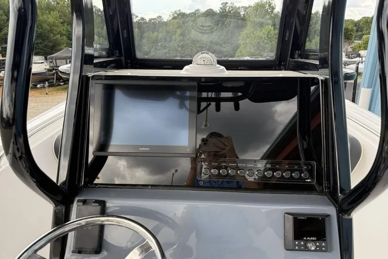 Slide: The Image of 2026 Tidewater 232 CC Adventure boat dashboard with Garmin display and control panel. - 15