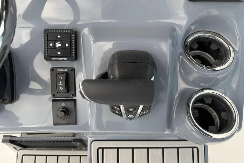 Slide: The Image of 2026 Tidewater 232 CC Adventure boat console with controls and cup holders. - 16