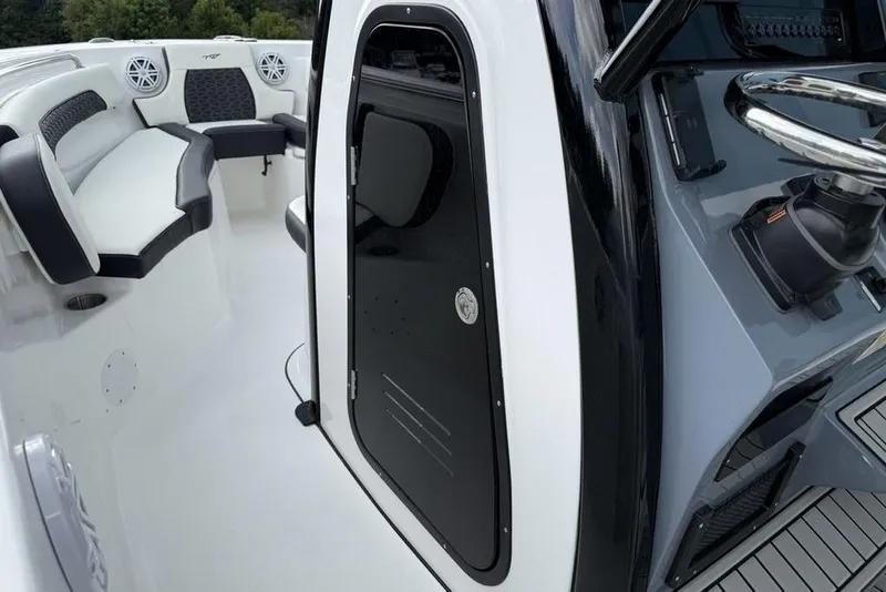 Slide: The Image of 2026 Tidewater 232 CC Adventure boat interior with seating and control panel. - 17