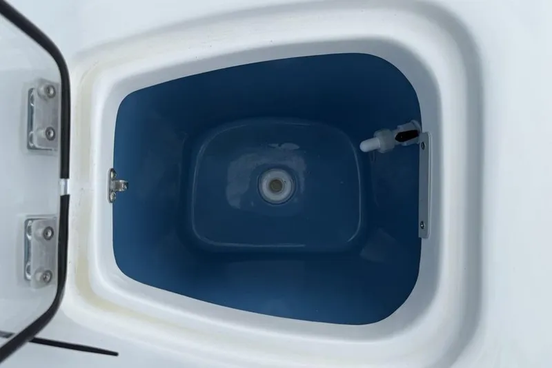 Slide: The Image of Livewell compartment of 2026 Tidewater 232 CC Adventure boat, featuring a blue interior. - 20
