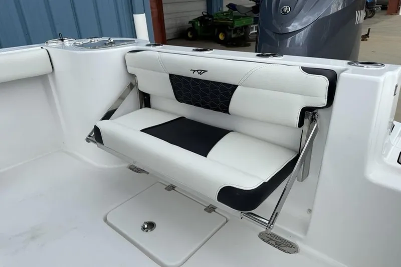 Slide: The Image of 2026 Tidewater 232 CC Adventure boat with white and black cushioned seating. - 21
