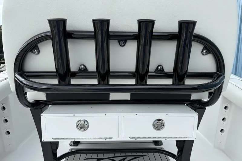 Slide: The Image of 2026 Tidewater 232 CC Adventure boat rod holders and storage compartment. - 22